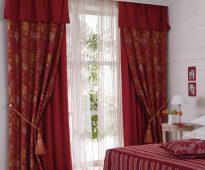 Tirai double burgundy dengan lambrequin grabs dan tulle di dalam bilik tidur