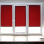 Fenêtre en plastique blanc avec rideaux rouges