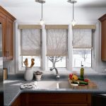 Valsade gardiner av naturmaterial på dörren till köksfönstret