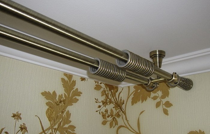 Metalli-karniisi, jossa on kiinnitys huoneen huoneen kattoon
